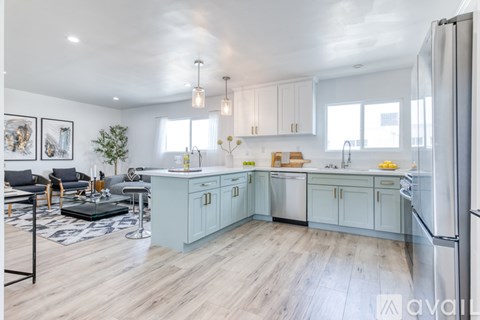 A kitchen with a blue cabinetry and a white fridge.