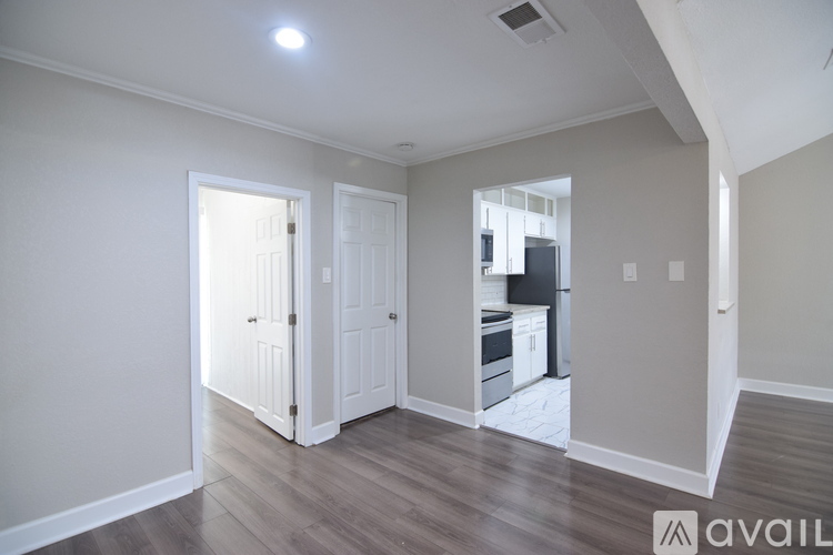 A kitchen with a black fridge and stove top oven.
