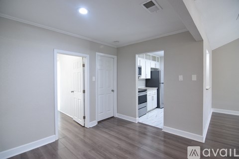 A kitchen with a black fridge and stove top oven.