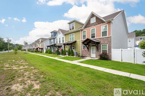 A row of houses with a grassy area in front.