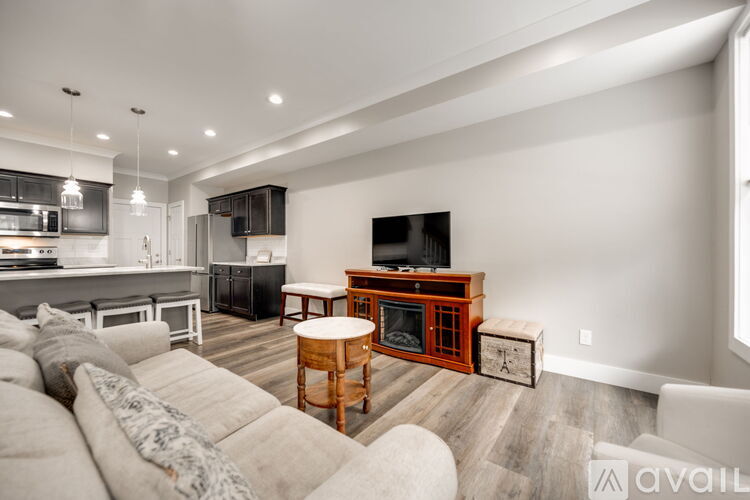 A modern living room with a white sofa and a wooden coffee table.