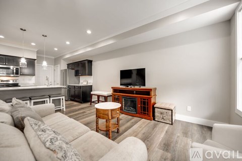 A modern living room with a white sofa and a wooden coffee table.
