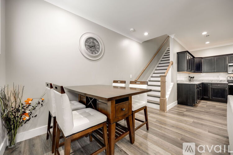 A dining area with a wooden table and chairs.