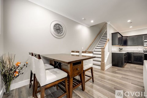 A dining area with a wooden table and chairs.