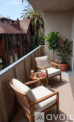 A room with a large window and a view of trees and a building outside.