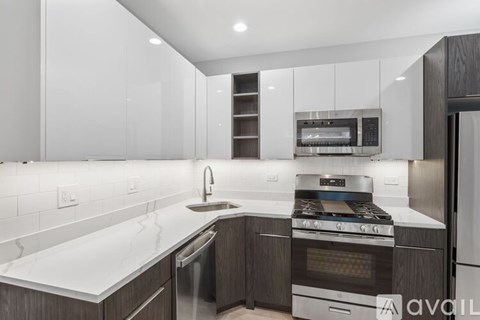 A modern kitchen with a stainless steel oven and a white countertop.