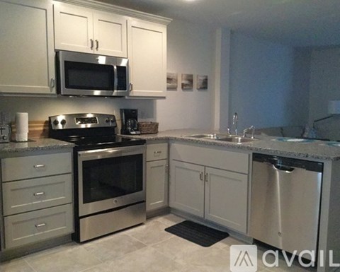 A kitchen with a stove top oven, microwave, and dishwasher.