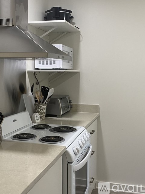 A white stove with a pot on it.