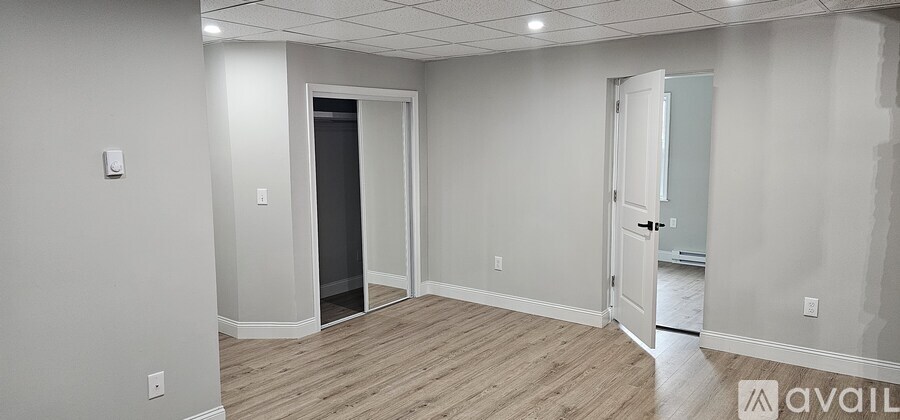 A room with a door and a wall socket.
