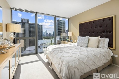 A bedroom with a large bed and a view of the city.
