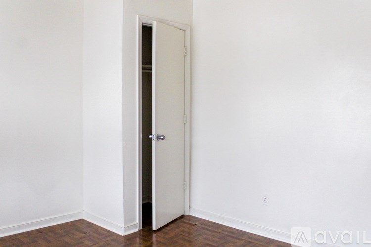 A white door is in a room with white walls.