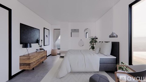 A modern bedroom with a large bed and a flat screen TV mounted on the wall.