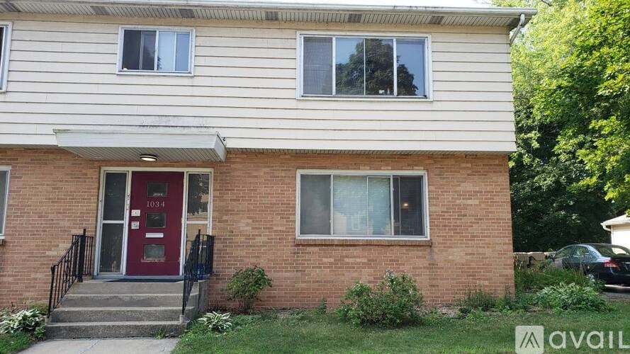 A house with a red door numbered 2031 is for sale.