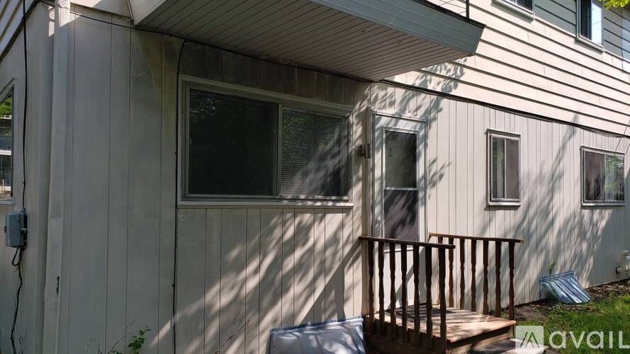 A house with a window and a door is available for rent.