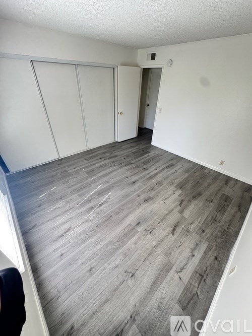 A room with a grey floor and white walls.