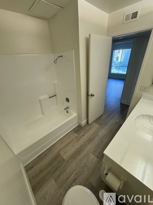 A bathroom with a toilet, sink, and bathtub.