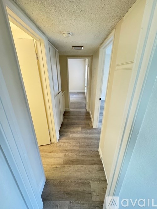 A long hallway with doors on both sides.