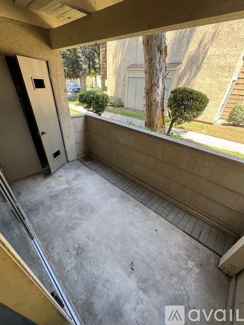 A small balcony with a door and a window.