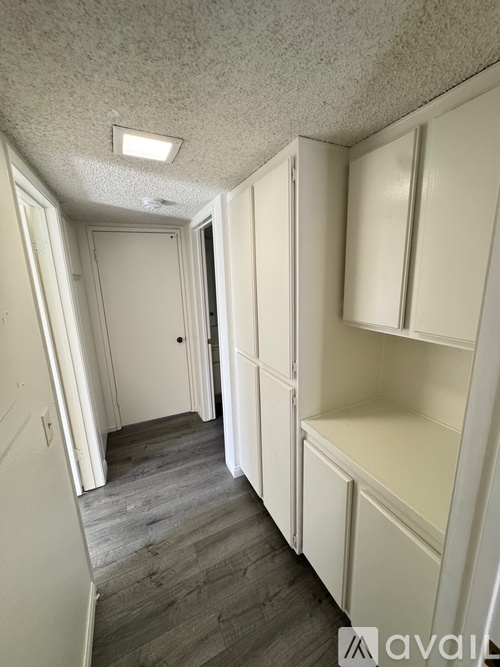 A kitchen with wooden cabinets and white appliances.