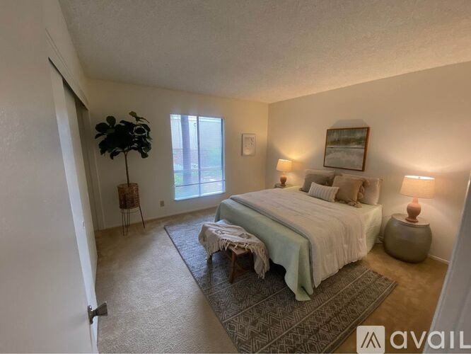 A bedroom with a large bed and a window.