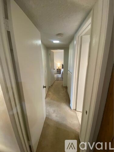 A long hallway with a light at the end.