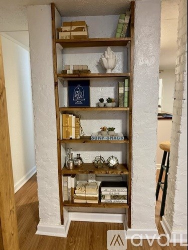 A tall wooden bookshelf with various items on it.