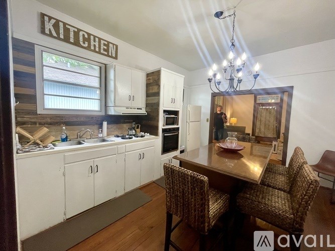 A kitchen with a dining table and chairs.
