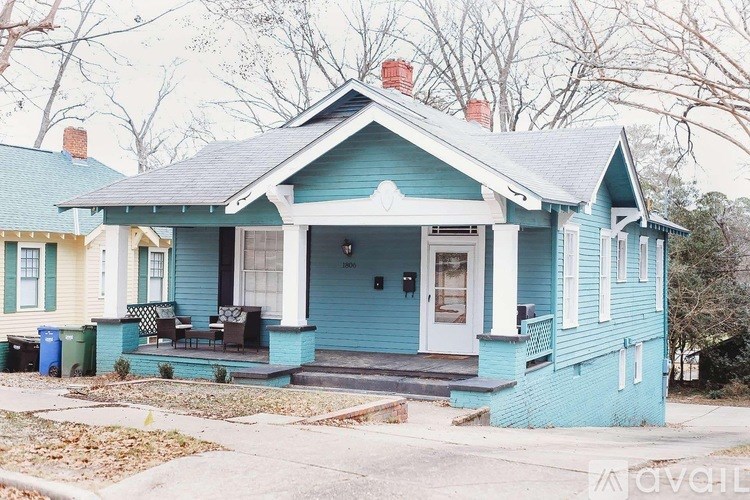 A blue house with a white door and windows.