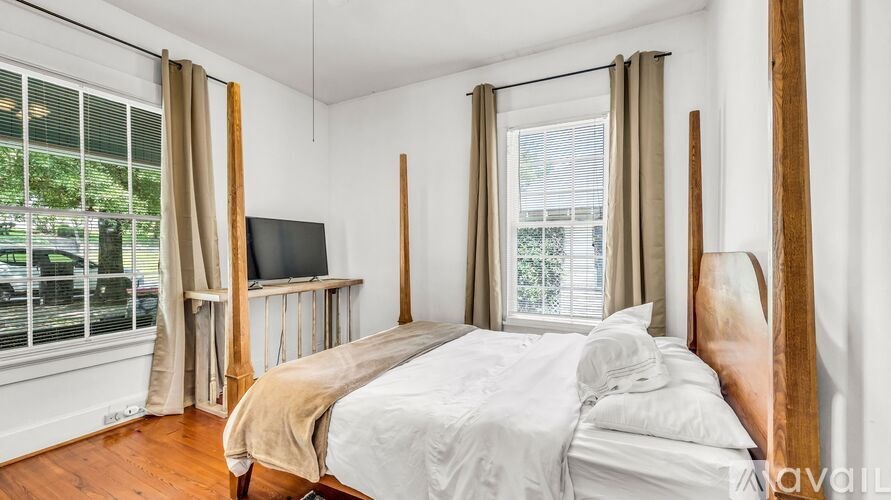 A bedroom with a large bed and a television.