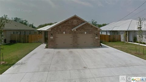 A house with a garage in front of it.