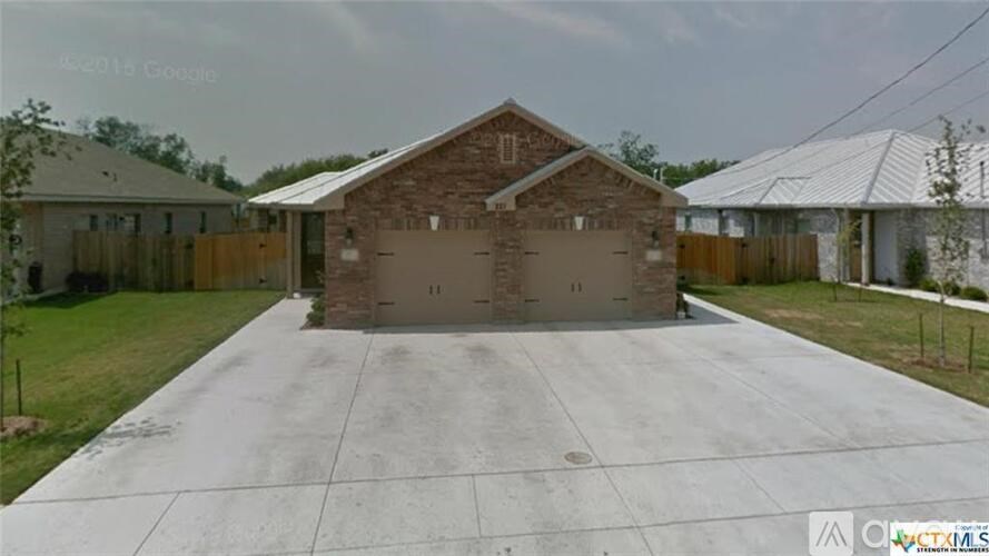 A house with a garage in front of it.