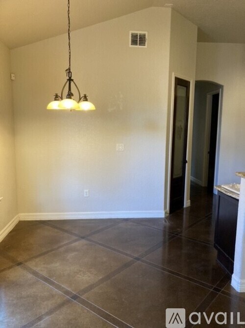 A room with a tiled floor and a hanging light fixture.