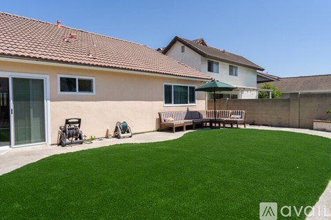 A house with a green lawn in front.