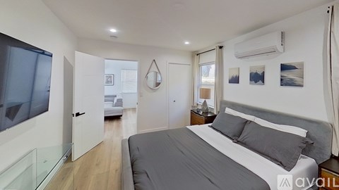 A bedroom with a large bed and a glass table.