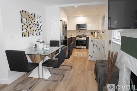 A modern kitchen with a dining table and chairs.
