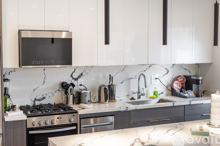 A kitchen with a black microwave above the stove.