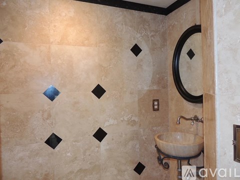 A bathroom with a sink and a mirror.