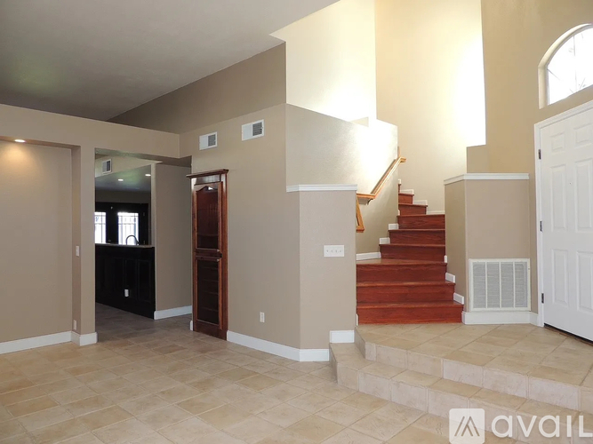 A living room with a staircase leading to the upper floor.