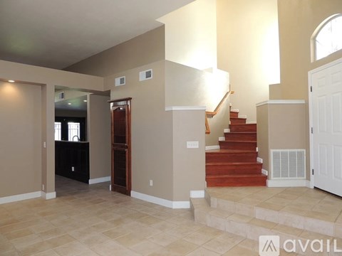A living room with a staircase leading to the upper floor.