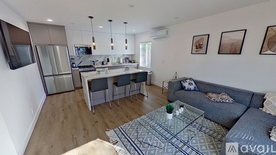 A modern living room with a grey couch and a coffee table.