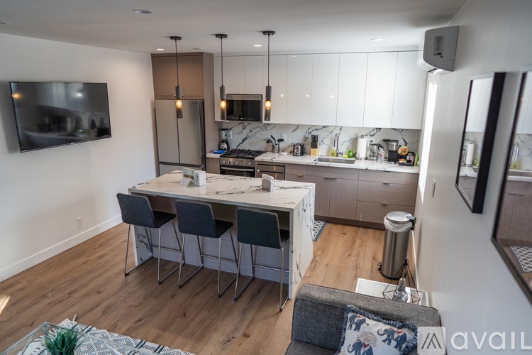 A modern kitchen with a dining table and chairs.