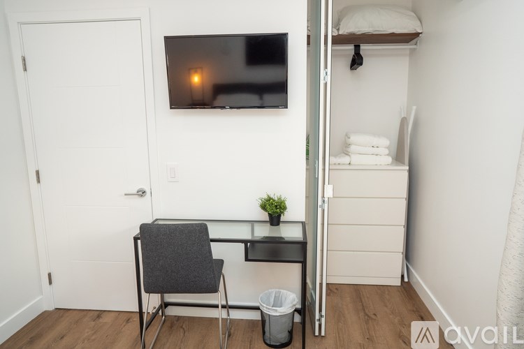 A small room with a desk and a chair.