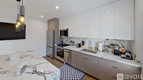A modern kitchen with a marble table and a sink.