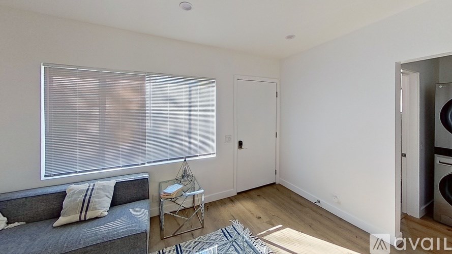 A living room with a grey couch and a small table.