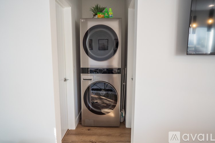 A modern stainless steel dishwasher is placed in a narrow kitchen space.