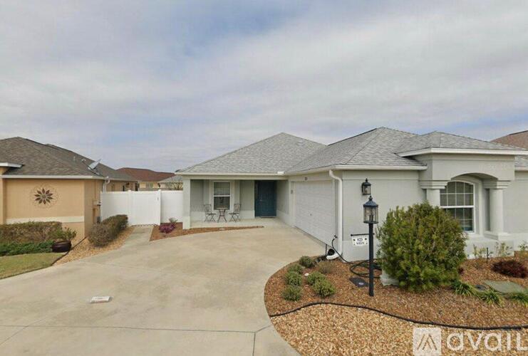 A house with a driveway and a sign that says "available".