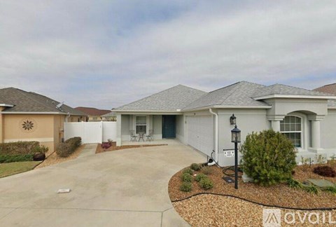 A house with a driveway and a sign that says "available".