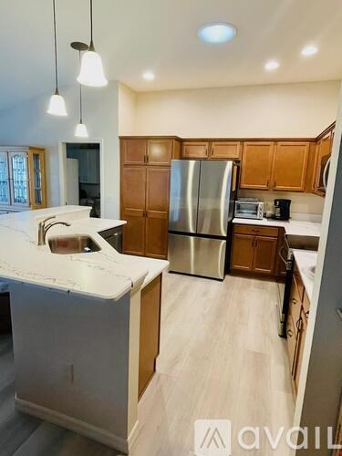 A kitchen with wooden cabinets and a white countertop.