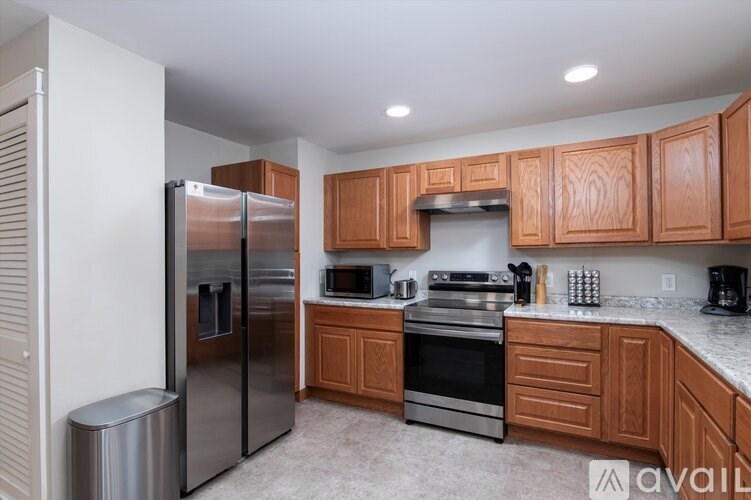 A kitchen with wooden cabinets and stainless steel appliances.