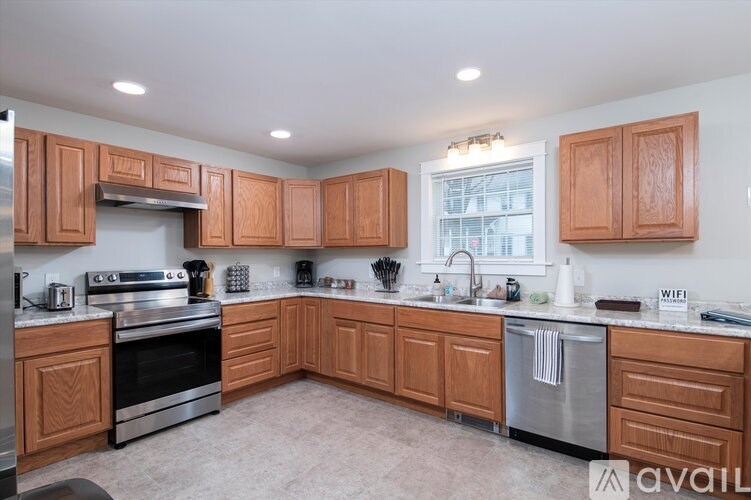 A kitchen with wooden cabinets and stainless steel appliances.